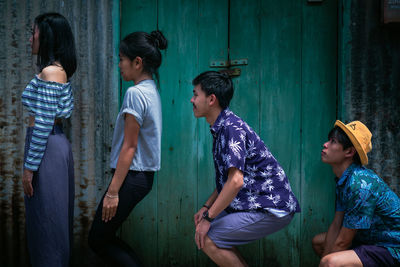 Group of people standing against the wall