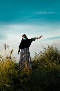 Man standing on field against sky