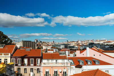 Houses in city against sky