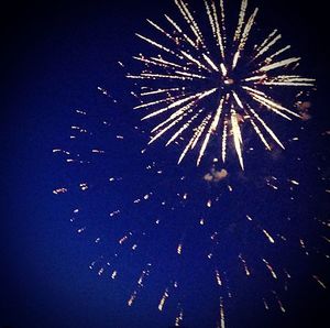 Low angle view of firework display at night