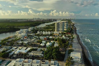 High angle view of buildings and sea against sky