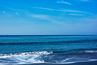 Scenic view of sea against blue sky