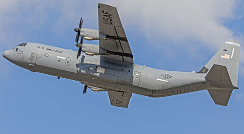 Low angle view of airplane flying against sky