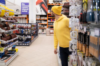 Rear view of woman standing in supermarket