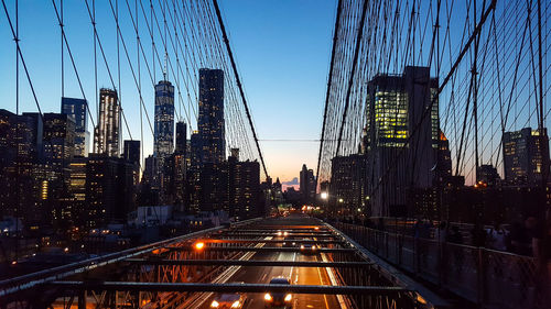 Bridge against cityscape at night