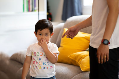 Mother instructing son at home