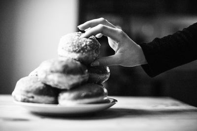 Cropped hand holding donut