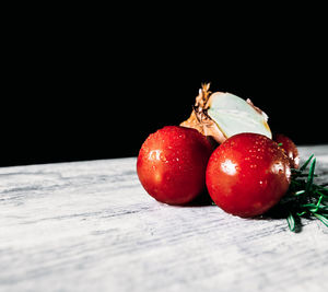 Close-up of strawberries on table against black background