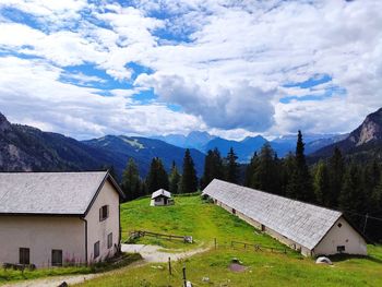 Scenic view of houses and mountains against sky