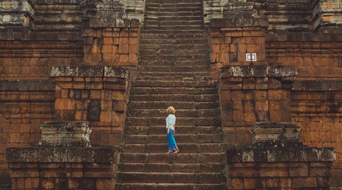 Full length of woman on steps of temple