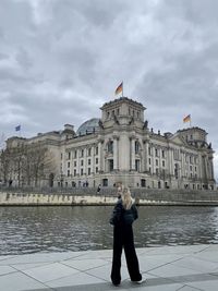 Rear view of woman standing outside german reichstag building