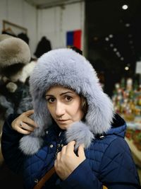 Portrait of mature woman wearing fur hat in store