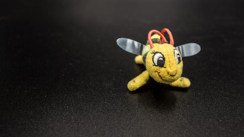 Close-up of toy car on table against black background