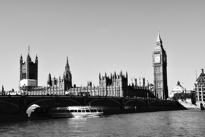 Bridge over thames river with buildings in background