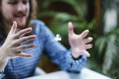 Young man catching feather