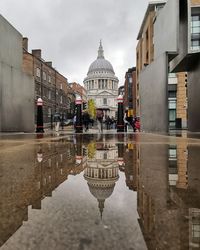 Reflection of buildings on water in city