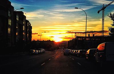 Cars on road at sunset