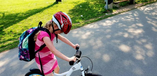 Rear view of people riding bicycle