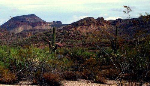 Scenic view of mountains against cloudy sky