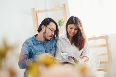 Young couple holding hands at home