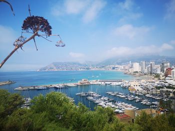 High angle view of cityscape by sea against sky