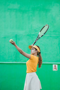 Rear view of woman playing tennis