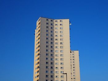 Low angle view of buildings against clear blue sky