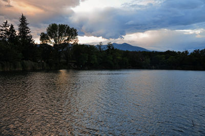 Scenic view of lake against cloudy sky