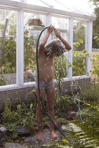 Girl taking shower in garden