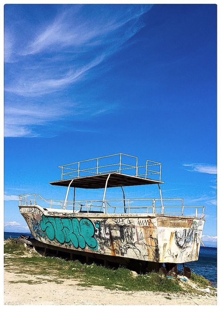 sky, blue, boat, tranquility, cloud, shore, nature, day, outdoors, tranquil scene, no people, absence, cloud - sky, scenics, beauty in nature, non-urban scene, grass, empty, idyllic