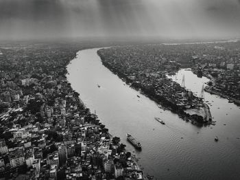 High angle view of buildings by sea against sky