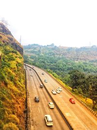 High angle view of cars on road against clear sky