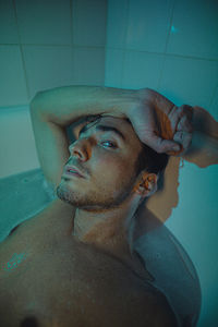 Portrait of young man in bathroom