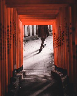 Low section of woman walking in corridor of building