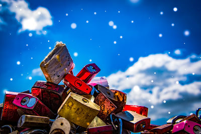 Low angle view of multi colored toy against blue sky