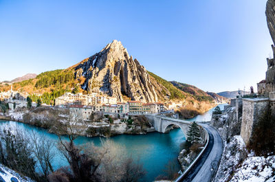 Panoramic view of mountains against clear blue sky