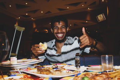 Portrait of a smiling man sitting in restaurant