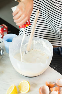 Woman kneading the dough while cooking apple pie in the modern kitchen