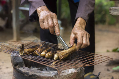 Man working on barbecue grill