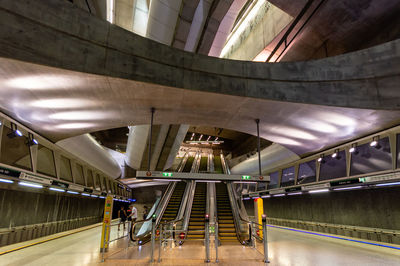 Escalator in illuminated underground walkway