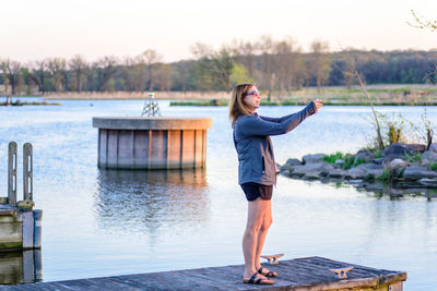 Full length of woman standing in lake