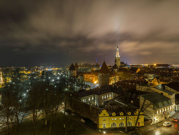 Illuminated cityscape against sky at night