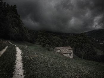 Scenic view of mountains against cloudy sky