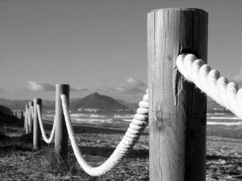 Close-up of wooden post against sky