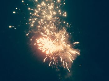 Low angle view of firework display at night