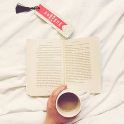 Directly above shot of coffee cup on bed