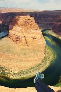 Low section of person against horseshoe bend