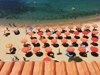 High angle view of multi colored umbrellas on sea shore