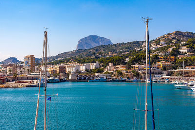 Sailboats in sea against sky