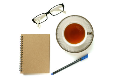 Directly above shot of coffee cup on table against white background